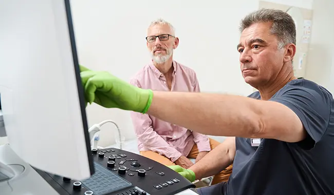 technician showing screen to patient