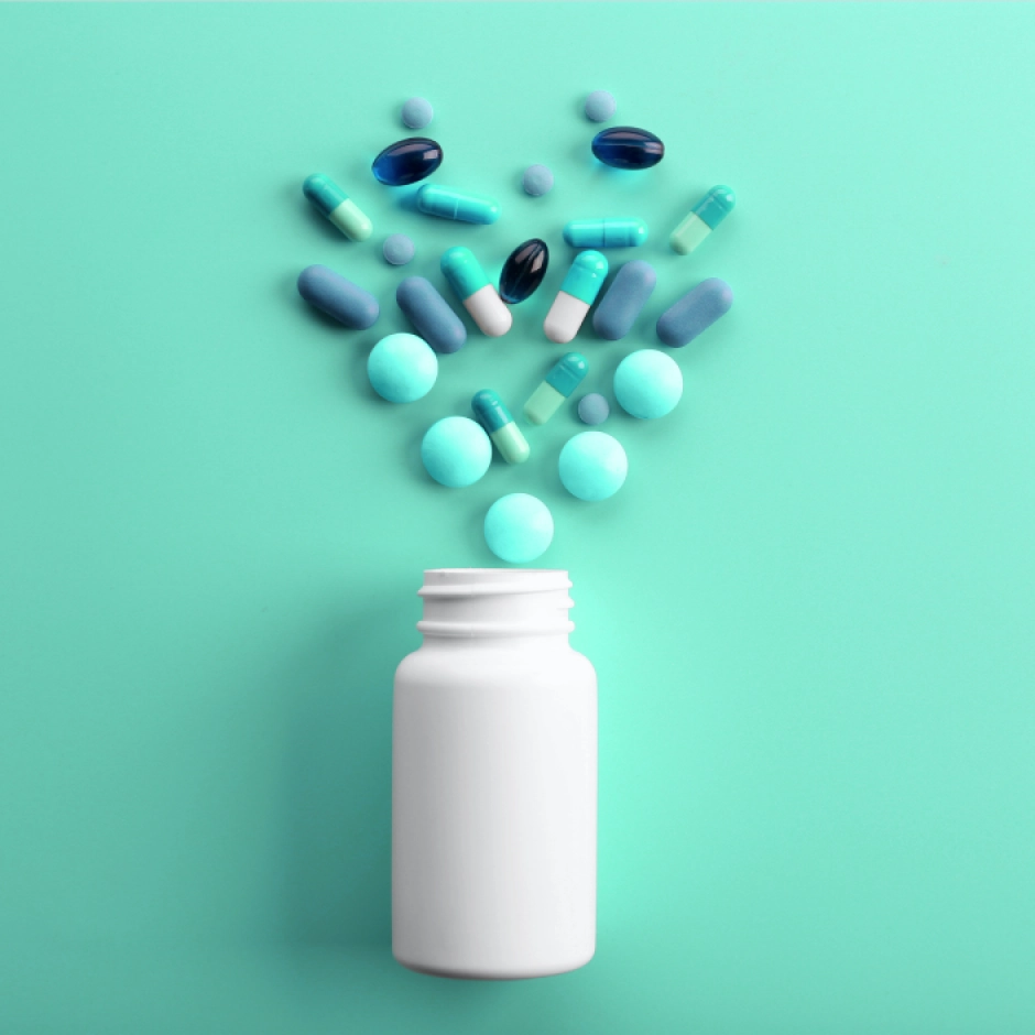bottle with variety of pills spilled out